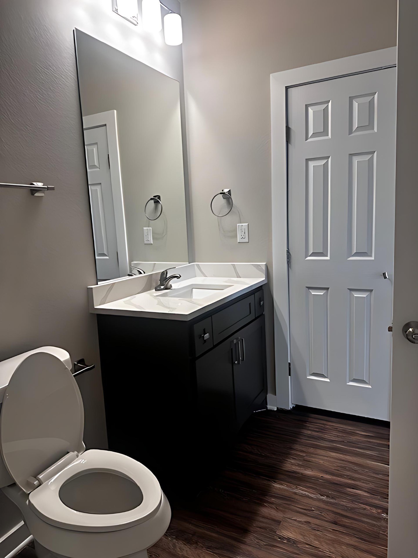 A white toilet sits next to a sink in a bathroom.